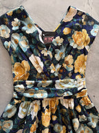 Midnight Floral Greta Dress, a black floral 1950s swing dress with a surplice neckline
