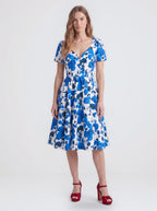 Lilith swing dress in Blue Fiori Dolce, a blue and white painted floral cotton sateen dress with a v neckline and full skirt, by Pinup Girl Clothing