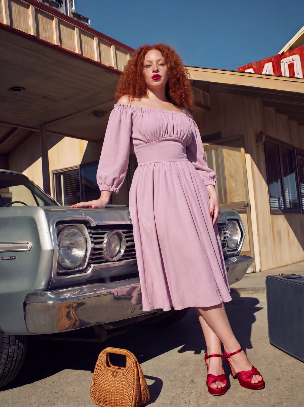 Marie-Therese peasant dress in Pinup Girl pink with red heels beside a vintage car, full midi skirt and puff sleeves