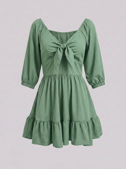 Ghost mannequin view of the Molly Mini dress in solid mint green, showing the tie-front bodice and tiered ruffle hem.