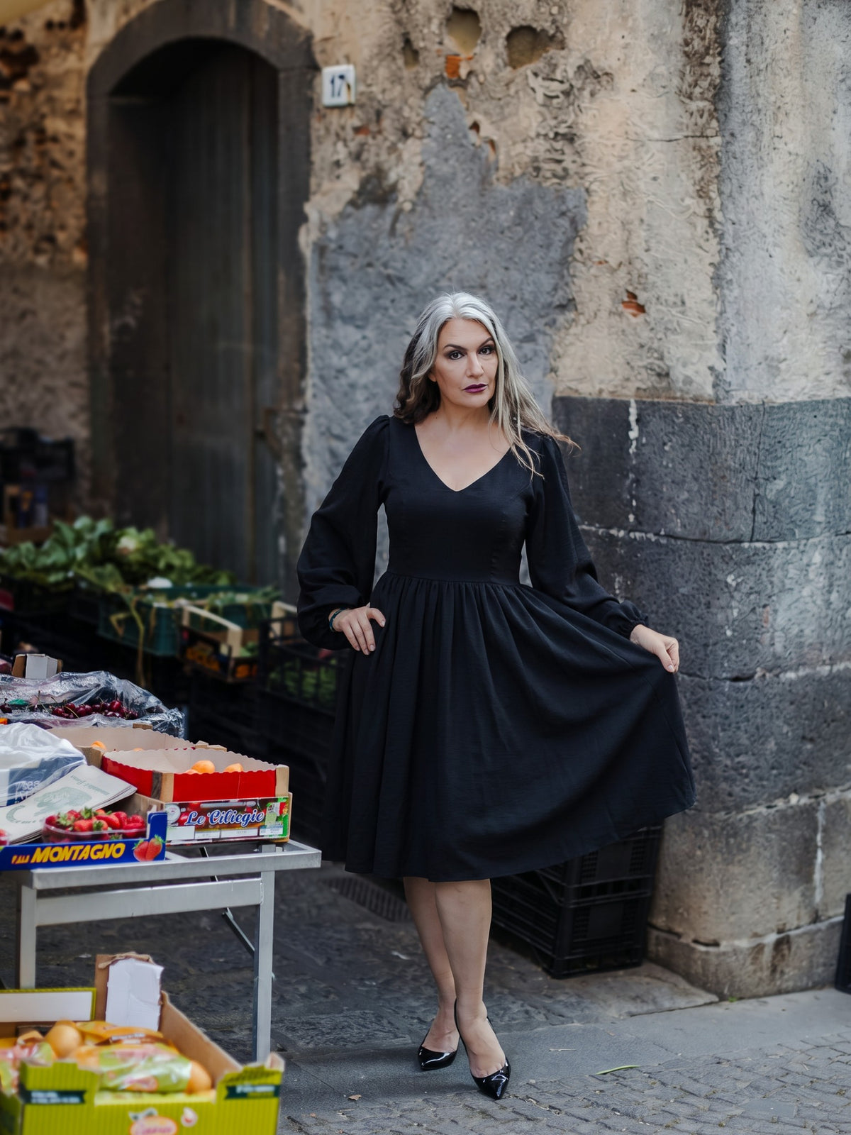 Kara swing dress in solid black with a plunging V neckline and full billowing sleeves, by Pinup Girl Clothing