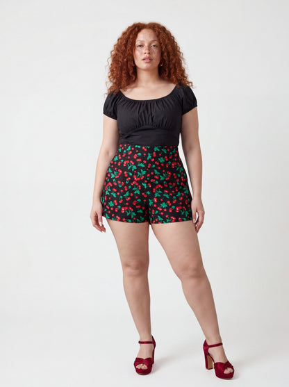 The LB High-Waisted Shorts in vintage cherries black, a Laura Byrnes design by Pinup Girl Clothing.