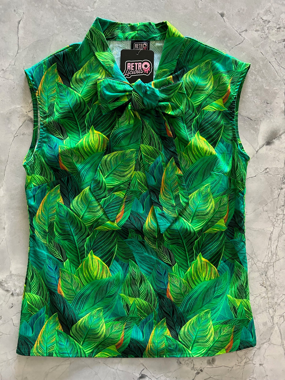 Leaves Bow Top in a green leaf print with an oversized neck bow