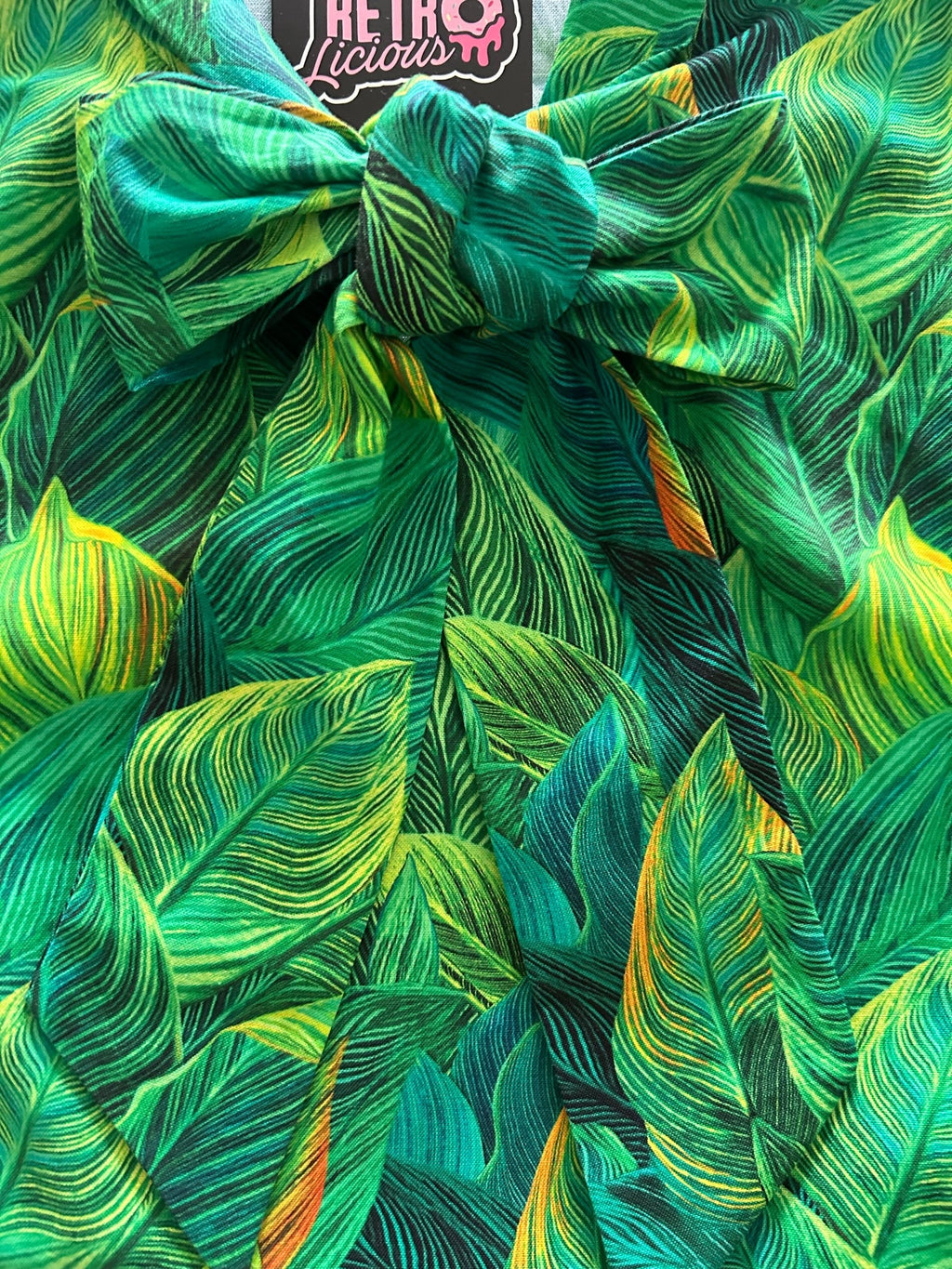 Leaves Bow Top in a green leaf print with an oversized neck bow