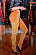 Waist-down view of the Lola high waist velvet leggings in mustard with black heels