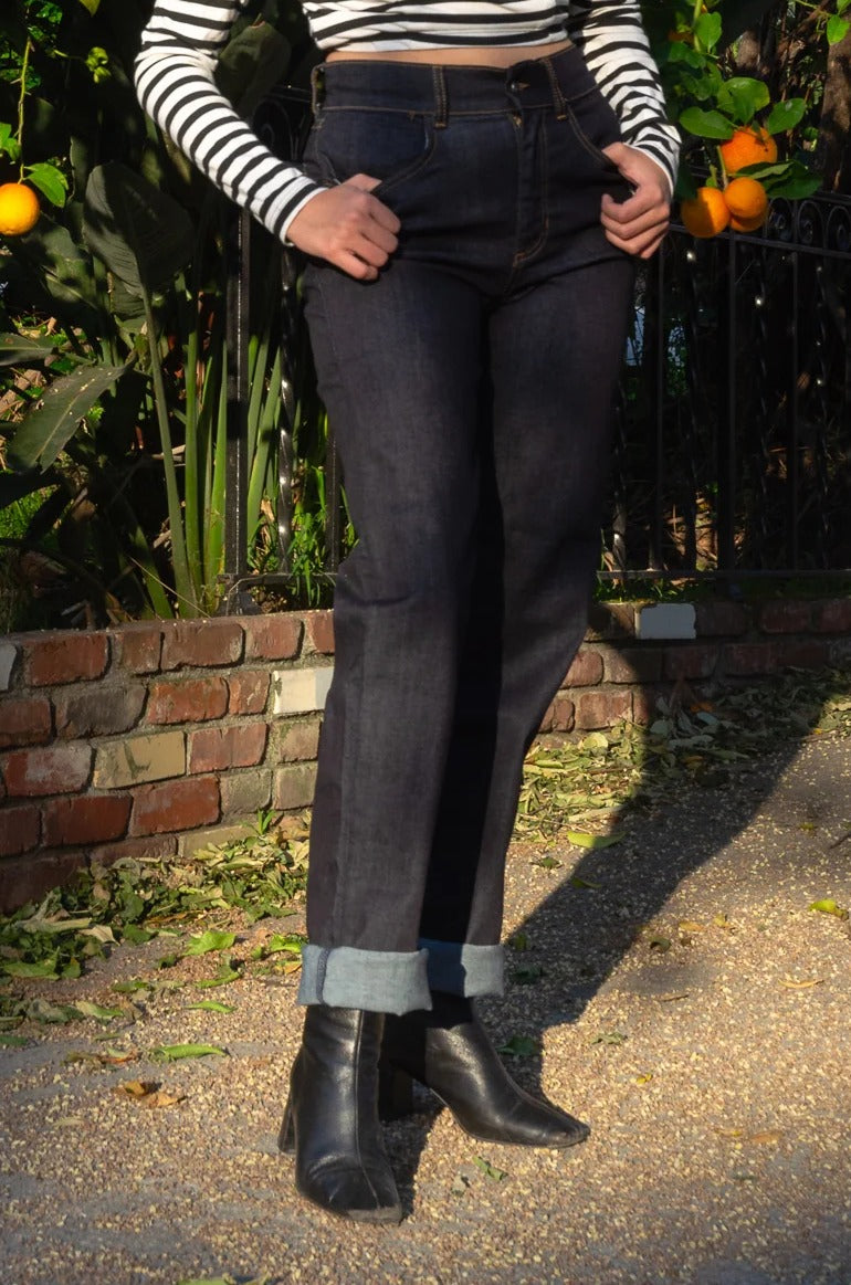 Waist-down view of the Love Your Body high waist boyfriend jeans, cuffed at the ankle, with black ankle boots
