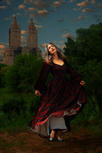 Lucrezia renaissance maxi gown in black on red Capri Floral in motion at dusk, the circle skirt lifting to show the lining