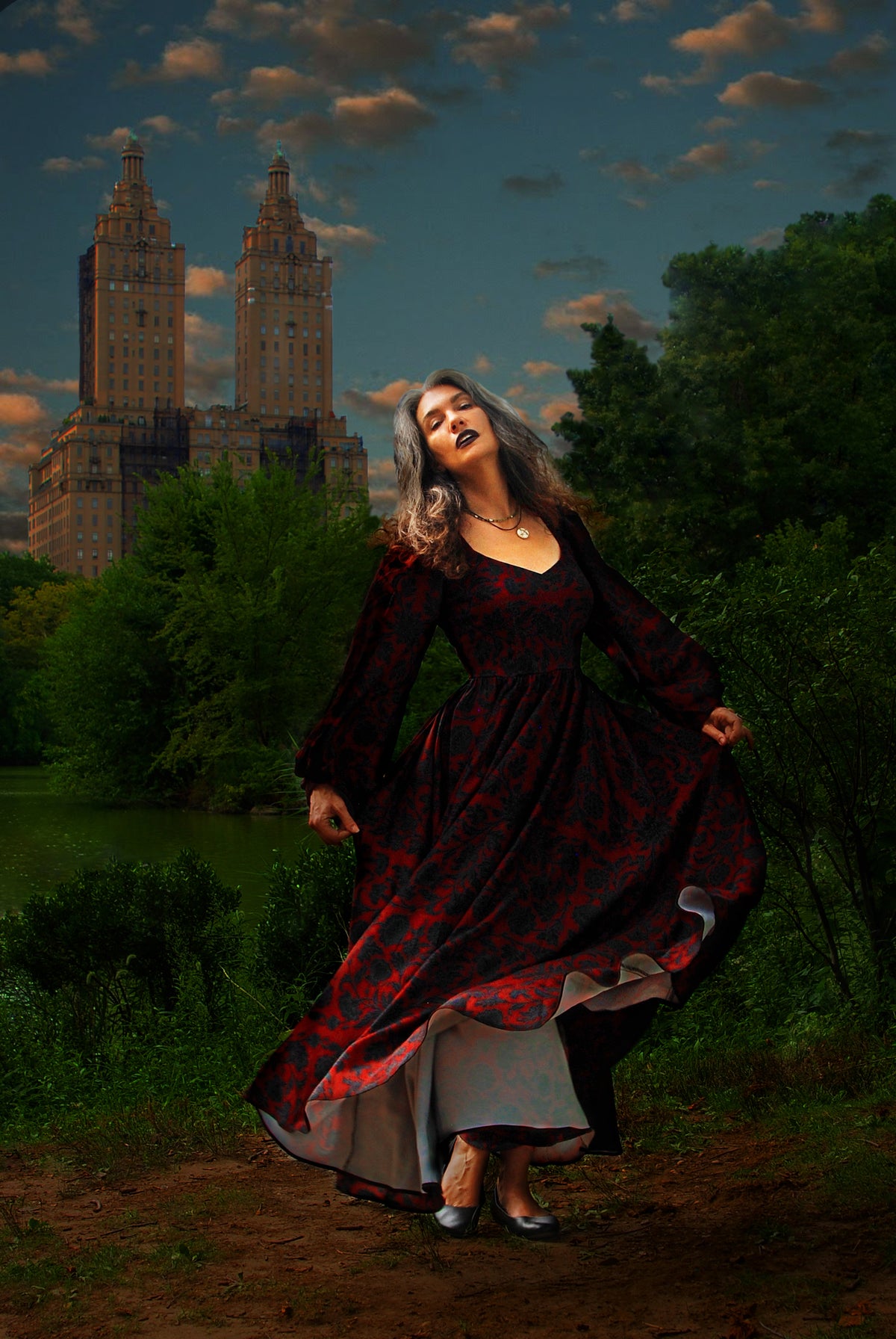 Lucrezia renaissance maxi gown in black on red Capri Floral in motion at dusk, the circle skirt lifting to show the lining