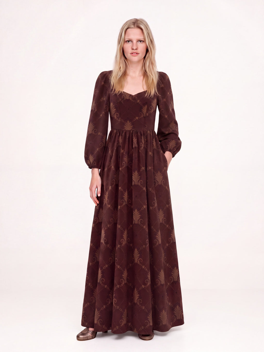 Brown Grand Trianon Lucrezia renaissance gown with a hand in the deep seam pocket, gathered circle skirt