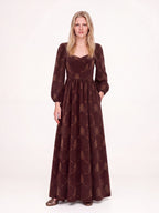 Brown Grand Trianon Lucrezia renaissance gown with a hand in the deep seam pocket, gathered circle skirt