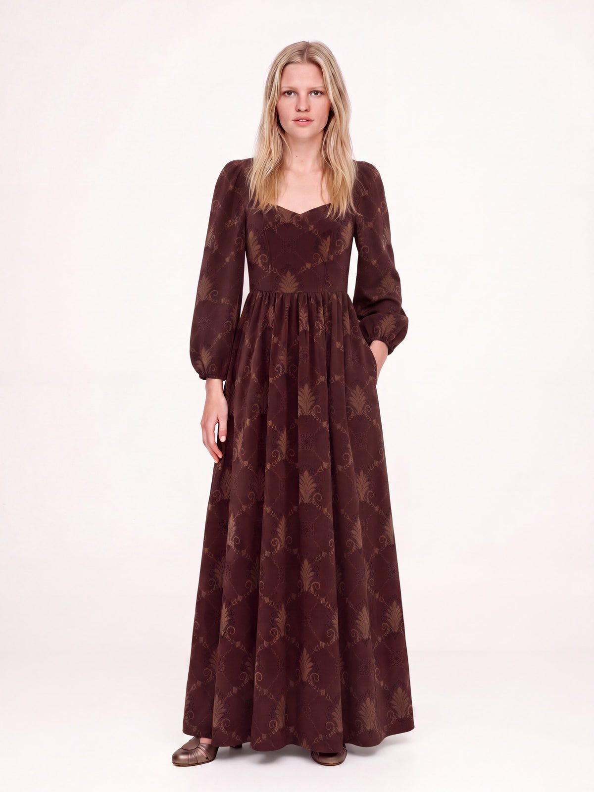 Brown Grand Trianon Lucrezia renaissance gown with a hand in the deep seam pocket, gathered circle skirt