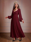 Model in the Lucrezia burgundy renaissance maxi gown, a deep wine-red floor-length dress with a sweetheart neckline, long bishop sleeves and a full gathered skirt with pockets