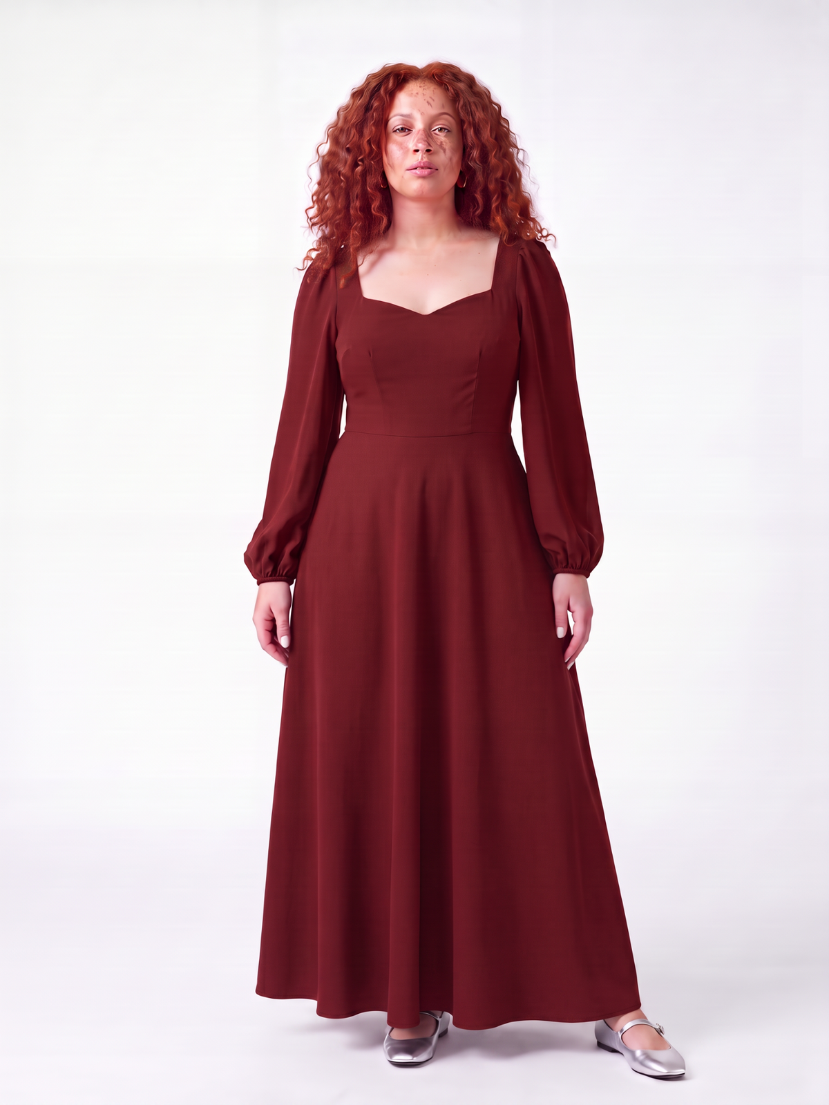 Model wearing the Lucrezia Renaissance Maxi Gown in Merlot, front view, a deep wine red with a sweetheart neckline, long bishop sleeves and a gathered circle skirt that grazes the floor