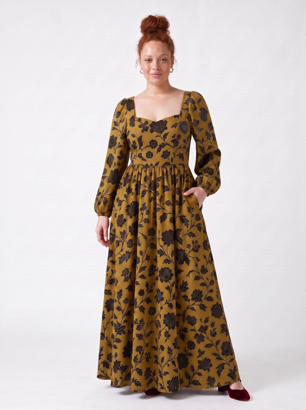 Lucrezia renaissance maxi gown in ochre Capri Floral with a hand in the deep in-seam pocket, gathered circle skirt to the floor
