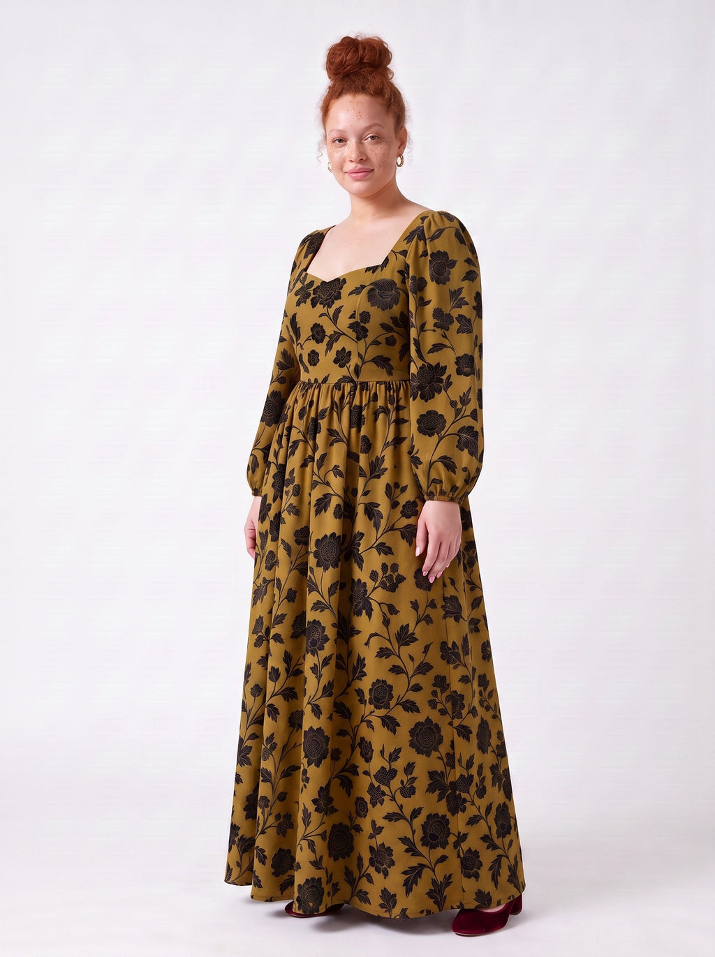 Side view of the Lucrezia renaissance maxi gown in ochre Capri Floral, black chrysanthemum print on gold stretch crepe