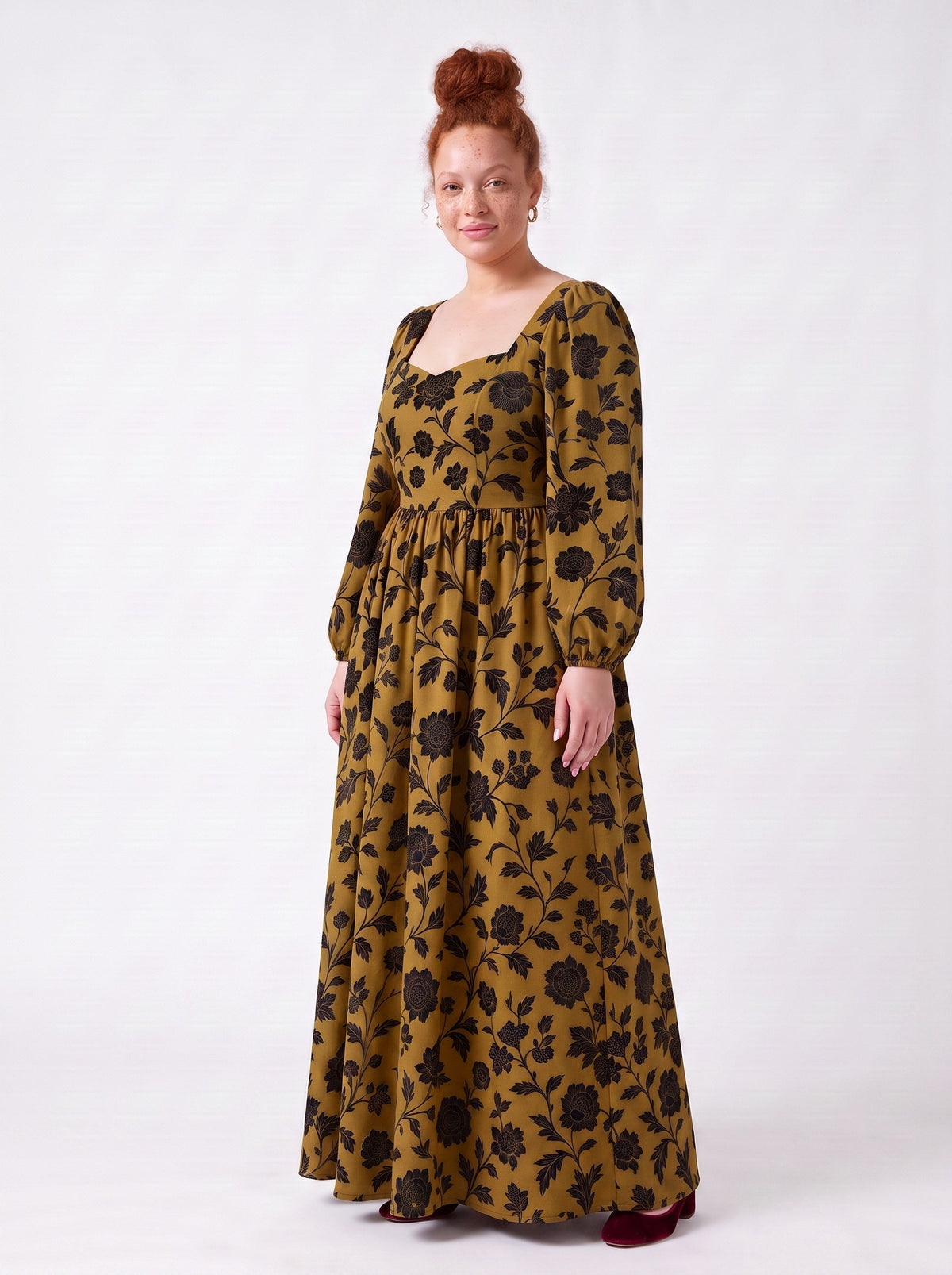Side view of the Lucrezia renaissance maxi gown in ochre Capri Floral, black chrysanthemum print on gold stretch crepe