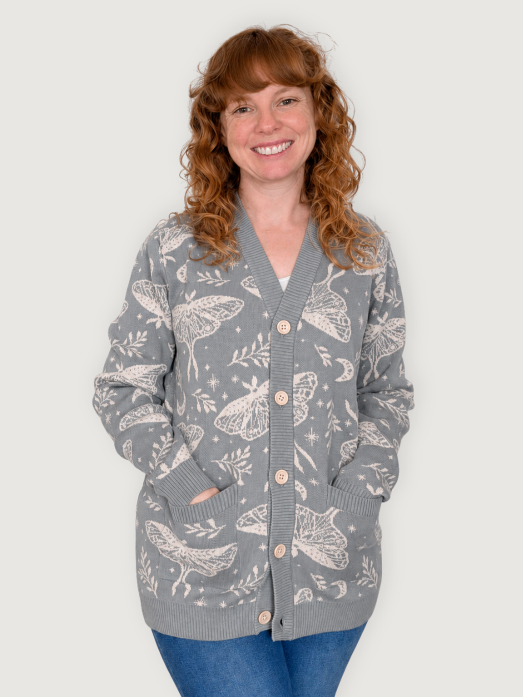 Woman wearing the Luna Moth Cardigan buttoned with her hands in the front pockets