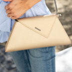Angelica metallic gold leather clutch carried by a model, another view, by Pinup Girl Clothing