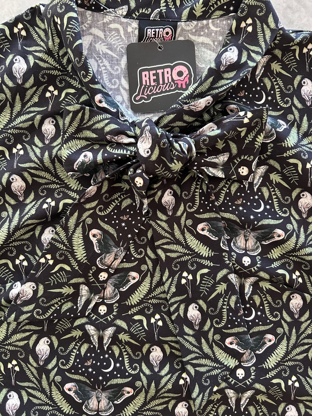 Midnight Bow Top in a black and cream botanical print with an oversized neck bow