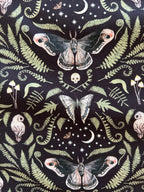 Midnight Bow Top in a black and cream botanical print with an oversized neck bow
