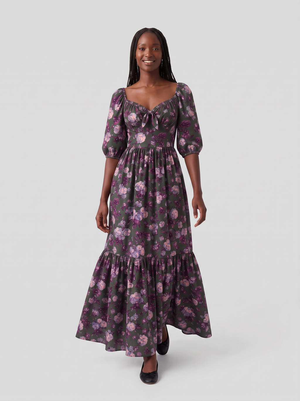 Model walking in the Molly 70s Maxi Gown in Oil Slick Ambrosia Floral, the tiered skirt swaying above black ballet flats
