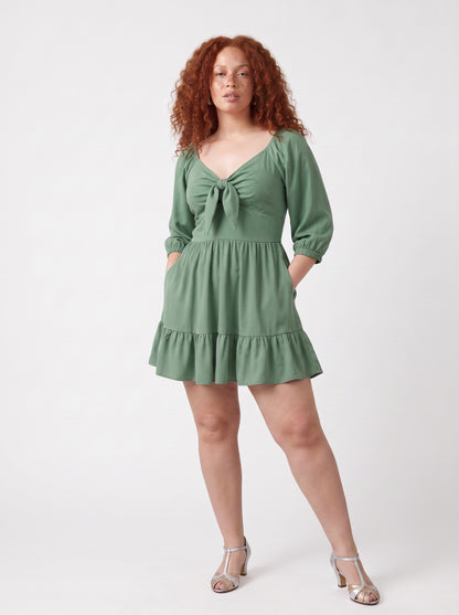 Molly Mini dress in mint green worn with hands in the deep-set skirt pockets, by Pinup Girl Clothing.