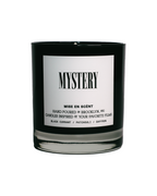 Mystery scented soy candle in a black glass jar