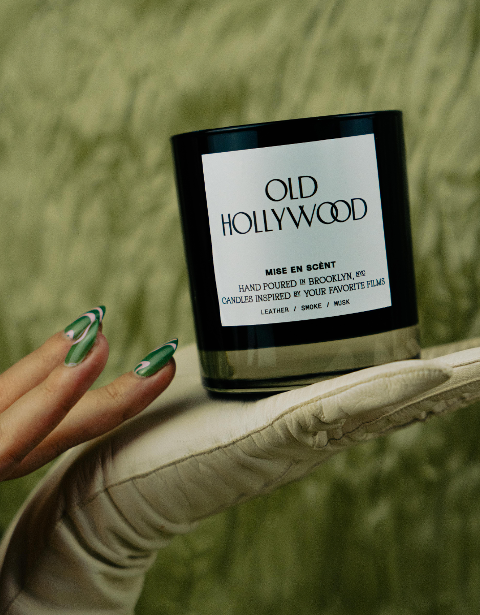 Old Hollywood candle held on a satin opera glove