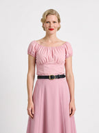 Front view of the vintage peasant top in Pinup Girl Pink worn with the Viva 40s tulip skirt in the same pink and a black belt