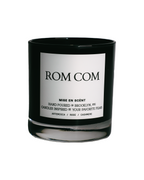 Rom Com scented soy candle in a black glass jar