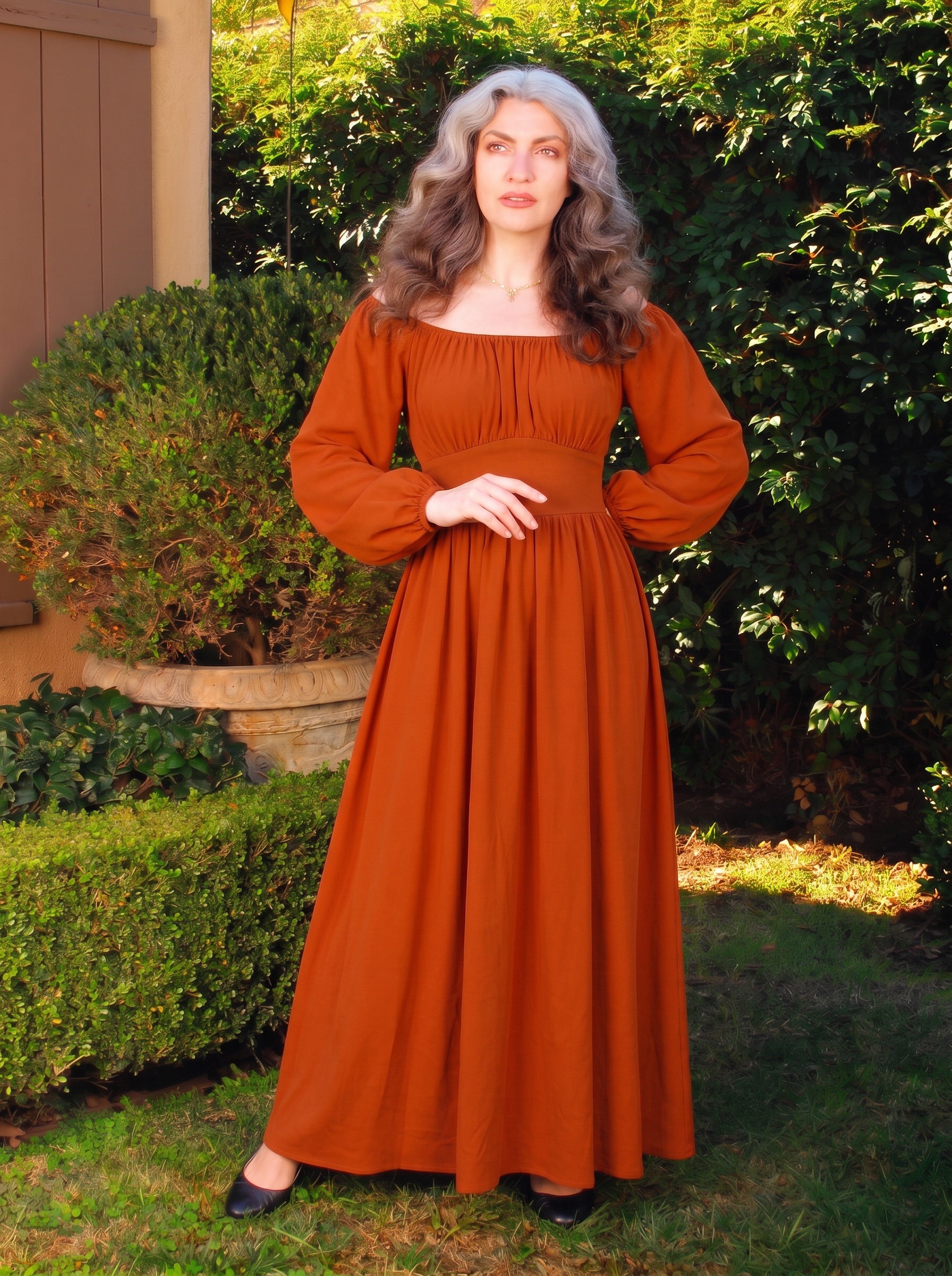 Swann Maxi Dress in Amber Harvest, a deep spiced orange floor-length maxi with a gathered off-shoulder neckline and a fitted waistband