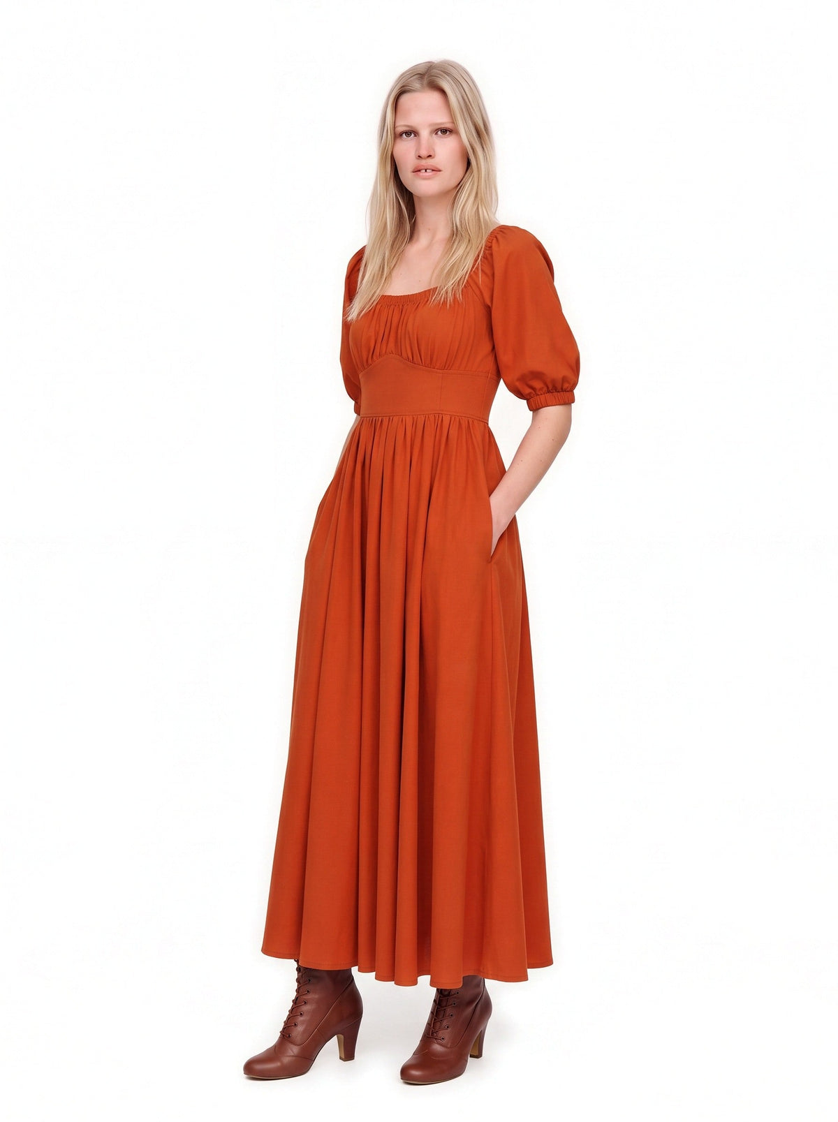 Amber Harvest Swann Maxi Dress worn up on the shoulders with a hand in the deep side-seam pocket of the full skirt