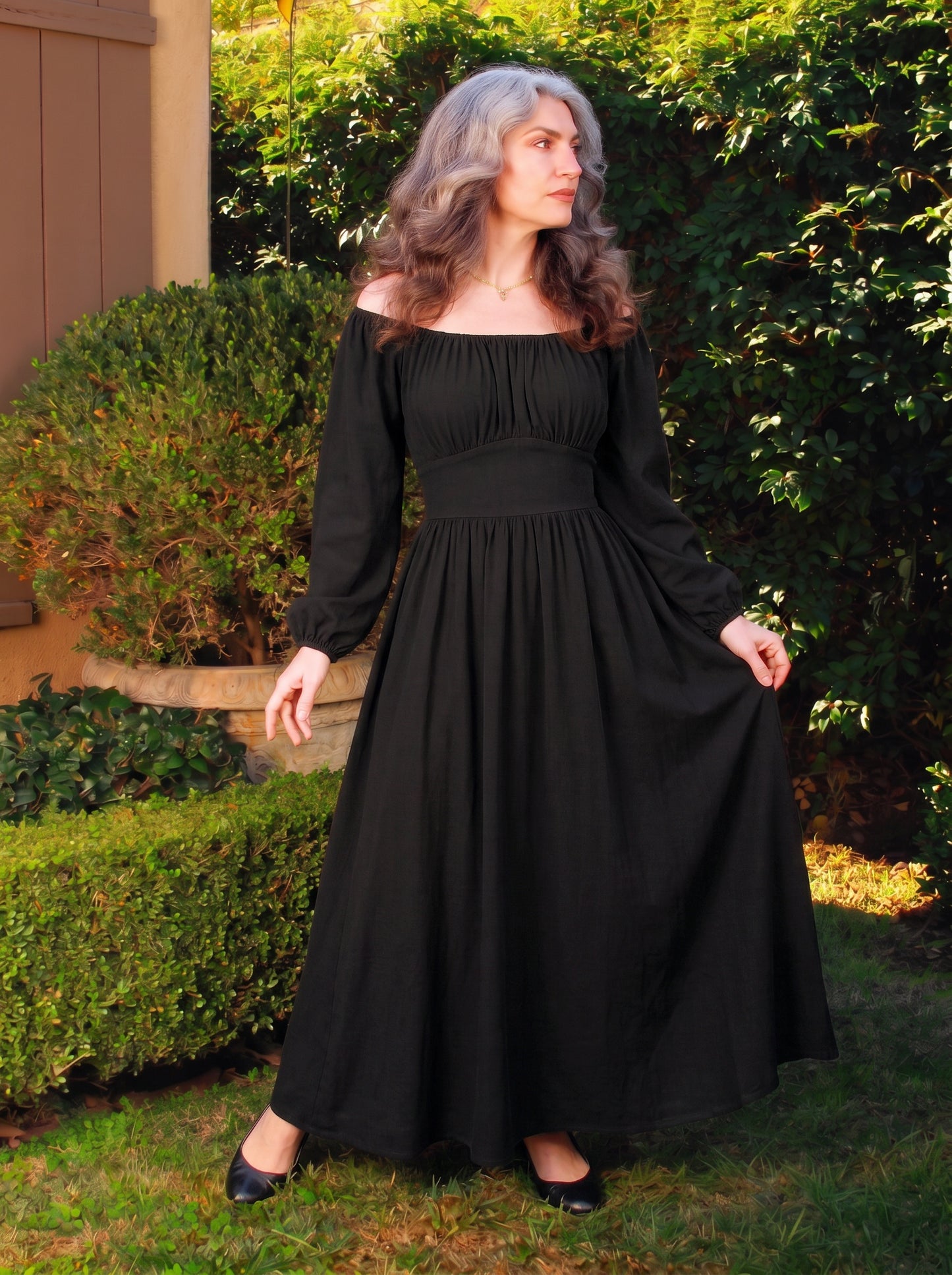 Swann Maxi Dress in solid black, a floor-length maxi with a gathered off-shoulder neckline, long blouson sleeves and a fitted waistband
