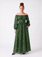Swann Maxi Dress in Black Serpente with a hand in the deep side seam pocket, gathered off-shoulder neckline and full skirt to the floor