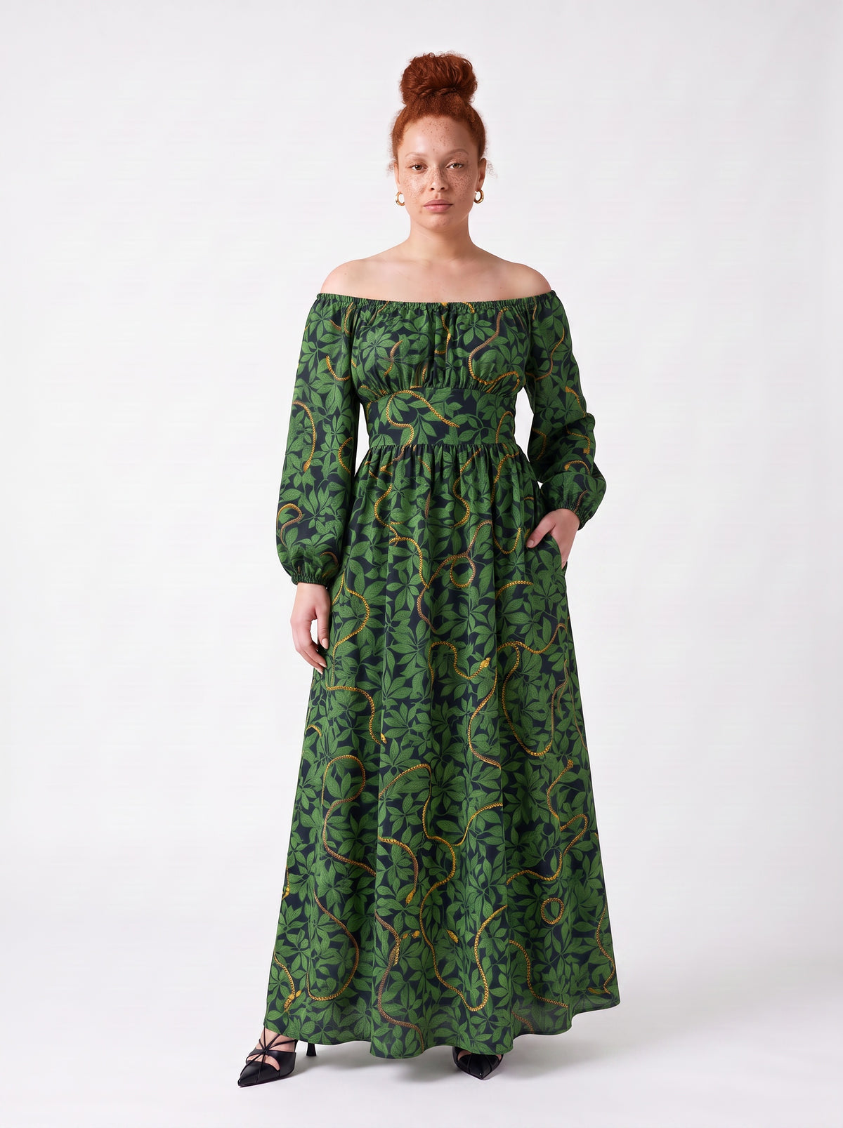 Swann Maxi Dress in Black Serpente with a hand in the deep side seam pocket, gathered off-shoulder neckline and full skirt to the floor