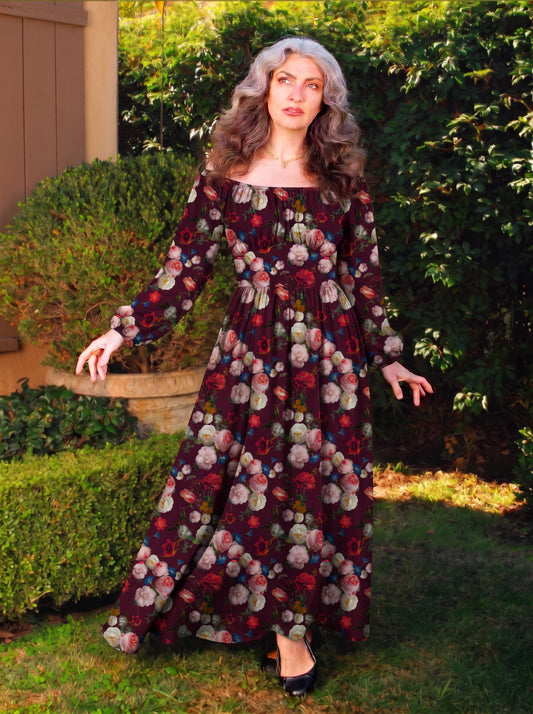 Swann Maxi Dress in Burgundy Ambrosia Floral, cream and pink roses with red carnations and blue cornflowers on a dark wine red ground, off-shoulder bodice and full maxi skirt