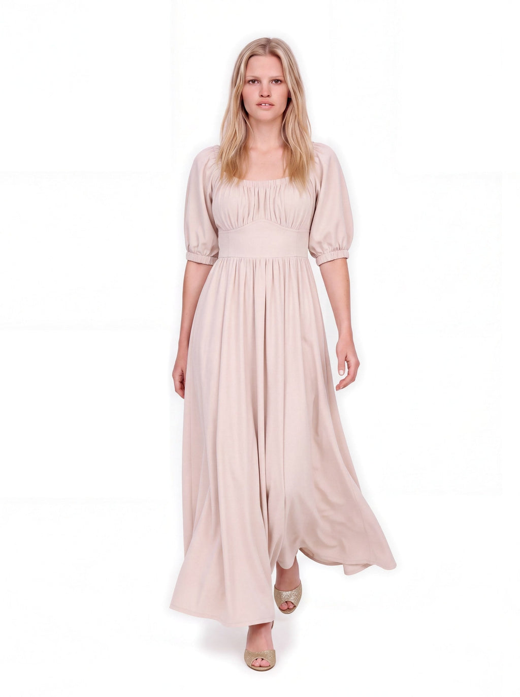 Swann Maxi Dress in Coconut Milk in motion, the full off-white crepe skirt sweeping to the floor, worn with gold heels