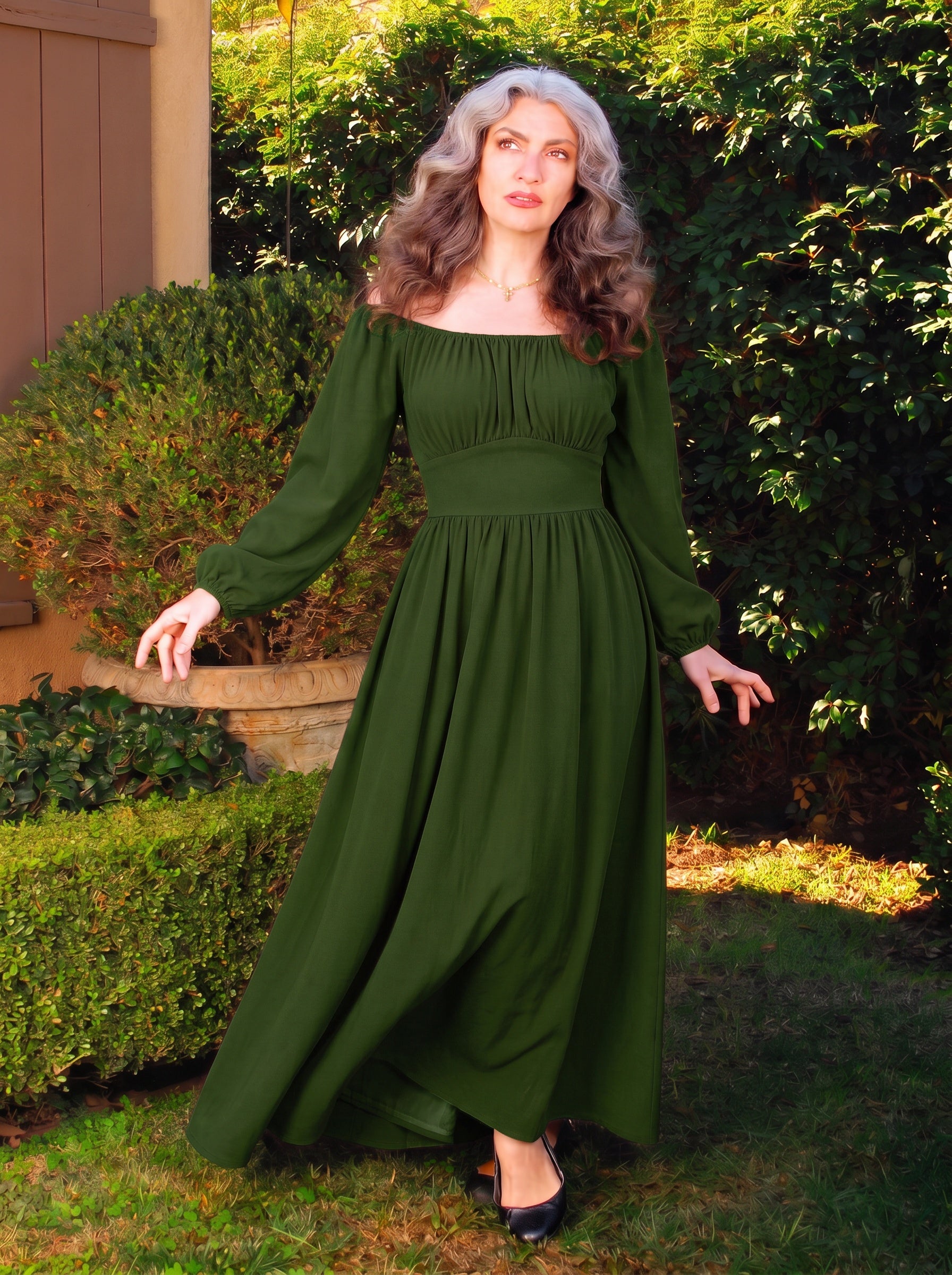 Full length view of the Hunter Green Swann Maxi Dress, blouson sleeves ending in elastic cuffs and a gathered skirt sweeping to the floor