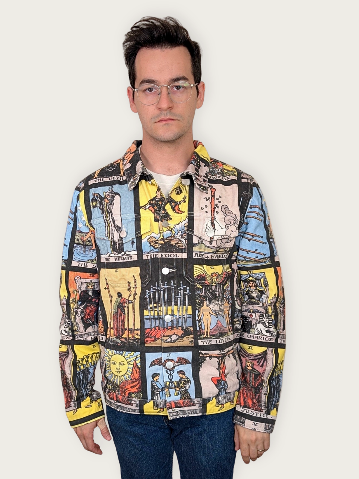 Tarot Card Denim Jacket worn buttoned, tarot card grid print across the chest and sleeves