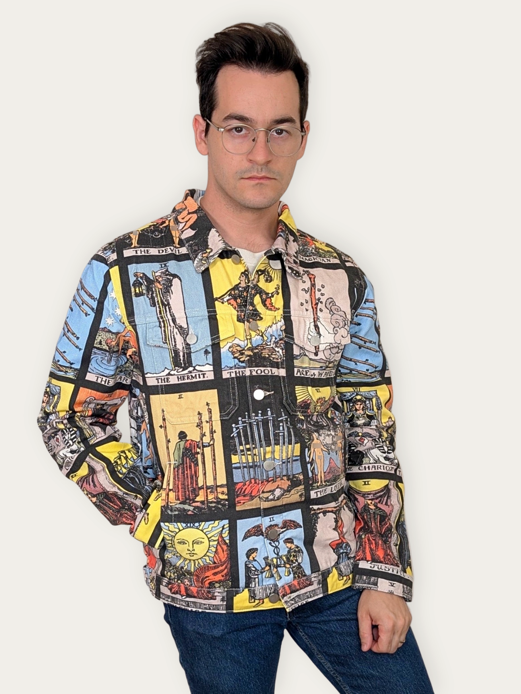 Front view of the Tarot Card Denim Jacket buttoned up, one hand at the front pocket