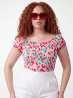 Pink vintage cherries peasant top with on-or-off shoulder bodice by Pinup Girl Clothing.