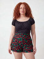 Vintage cherries LB high-waisted shorts in black by Pinup Girl Clothing, sizes XS to 5X.