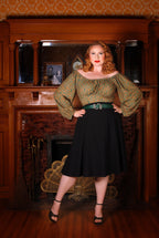 Full length view of the Viva 40s tulip swing skirt in black, high waist and flared knee-length skirt, styled with a green peasant top and black heels