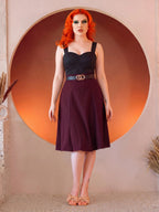 Model in the Viva 40s Tulip Skirt in Burgundy with a black sweetheart top and gold ring belt, full length front view