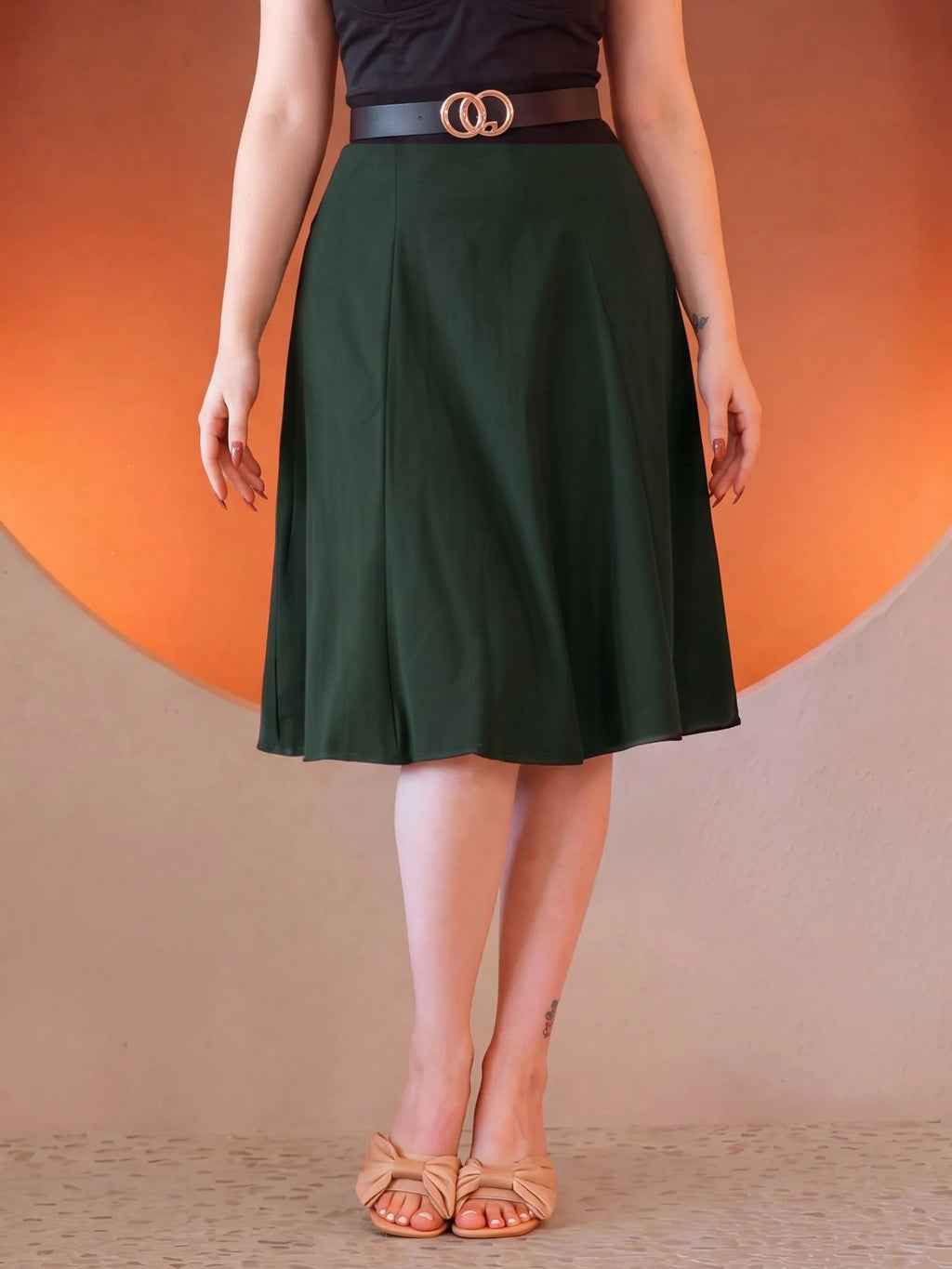 Viva 40s Tulip Skirt in Hunter Green from the waist down, high waist with a gold ring belt, paneled skirt flaring to just below the knee, worn with tan bow sandals