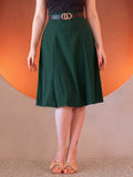 Viva 40s Tulip Skirt in Hunter Green from the waist down, high waist with a gold ring belt, paneled skirt flaring to just below the knee, worn with tan bow sandals