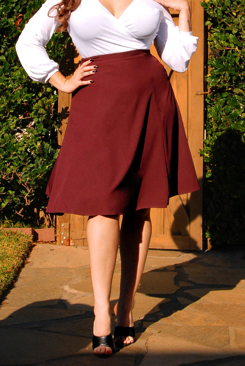 Waist-down view of the Viva 40s tulip skirt in eggplant crepe with black heels