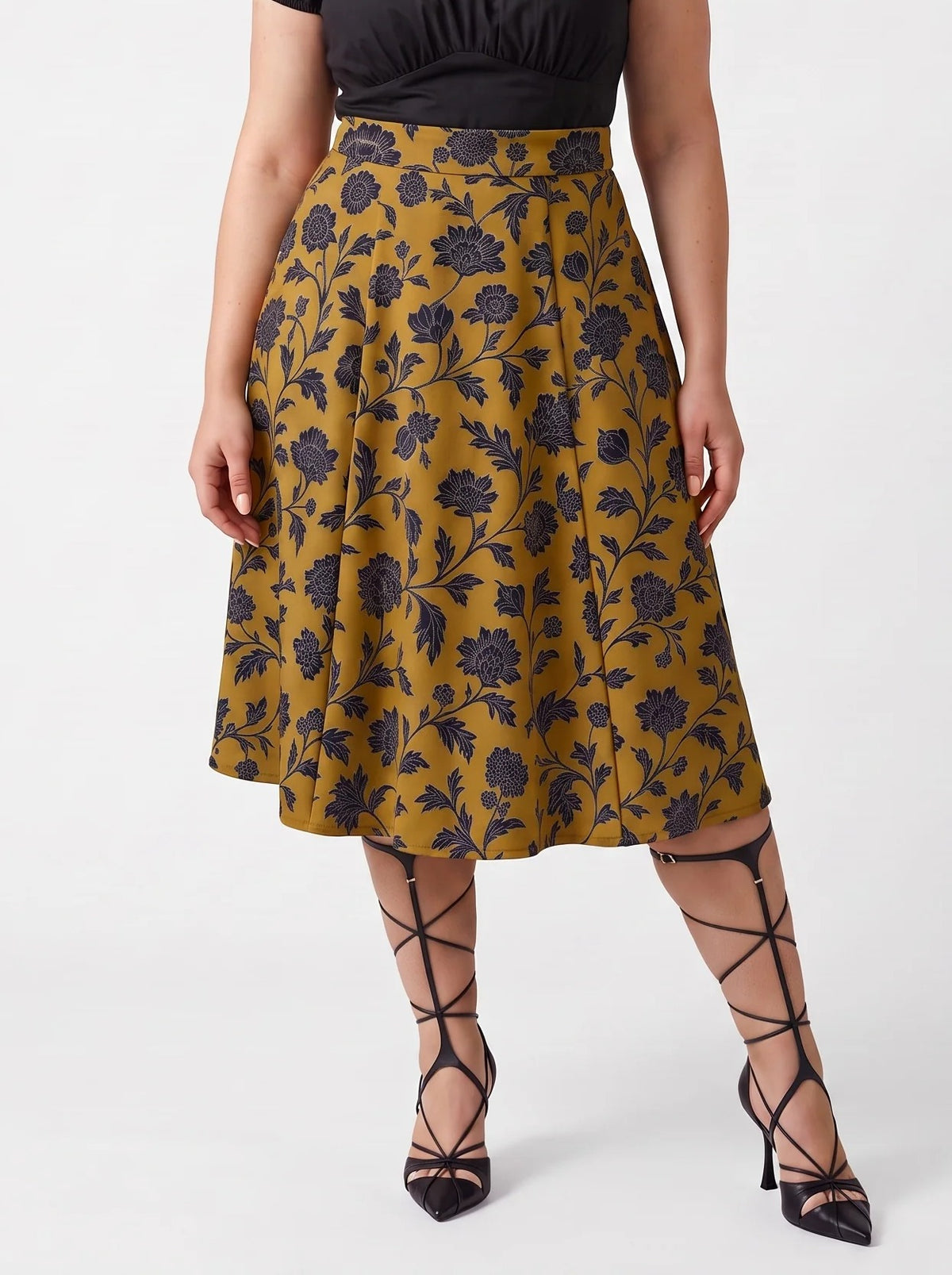Waist-down view of the Viva 40s tulip skirt in ochre Capri Floral with black lace-up heels