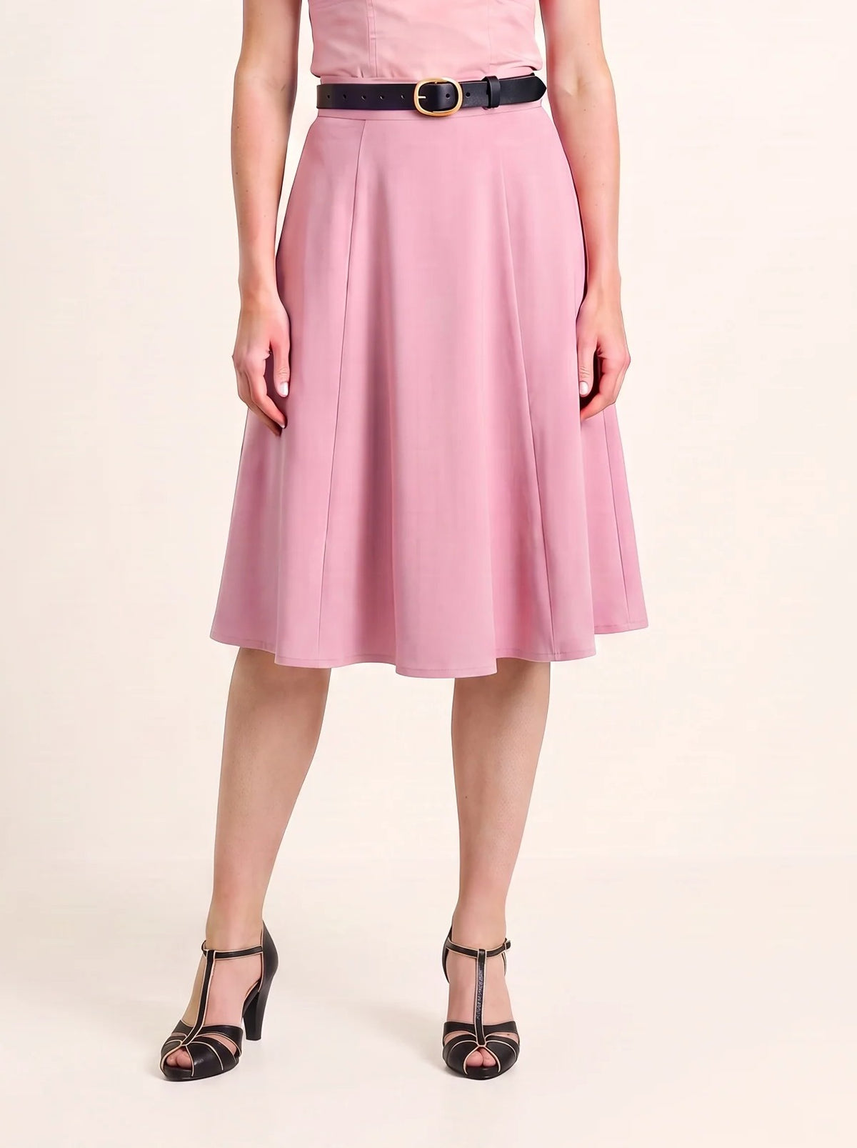 Waist-down view of the Viva 40s tulip skirt in Pinup Girl Pink with a black belt and black T-strap heels