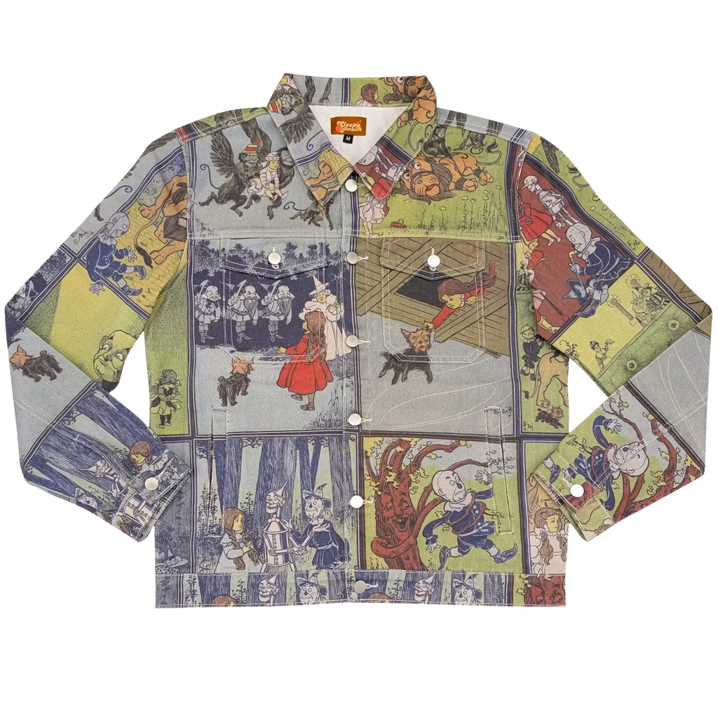 Wizard of Oz Denim Jacket laid flat, denim printed with vintage Wizard of Oz storybook panels in blue, green and cream